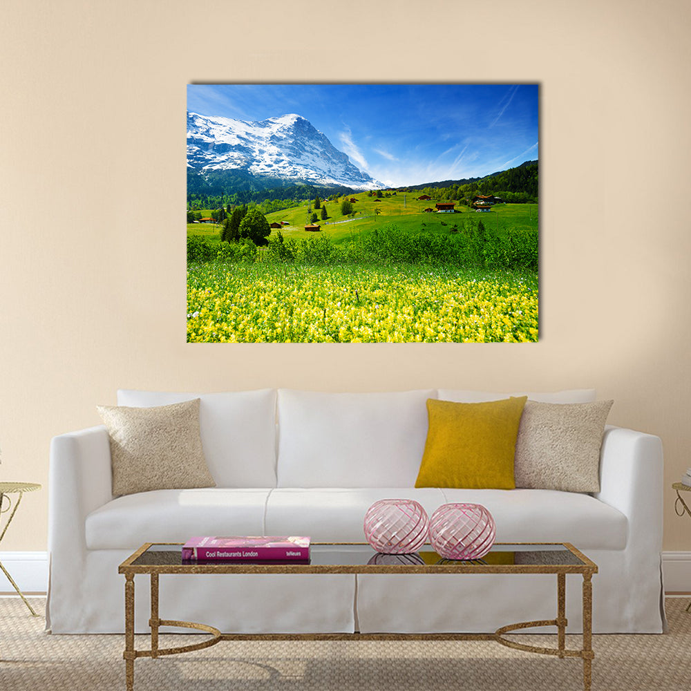 Swiss Alpine Wildflower Meadow Canvas Wall Art in yellow, green and blue, single panel hung on a wall