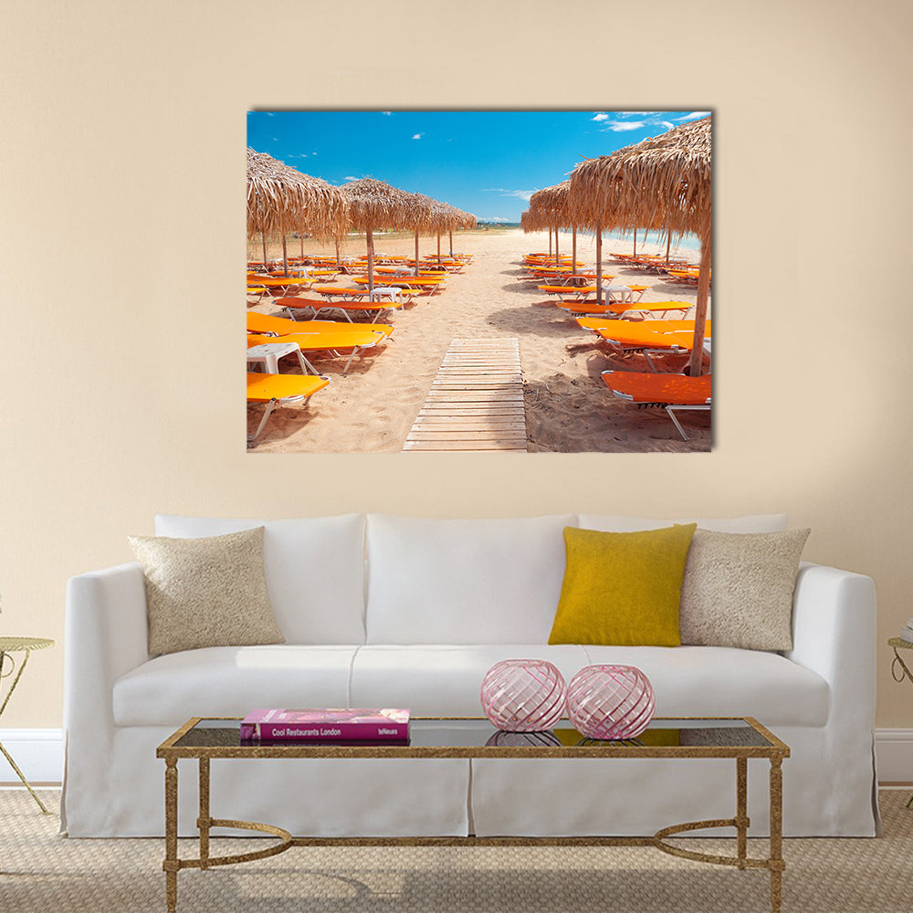 Greek Beach with Wooden Walkway and Orange Loungers Canvas Wall Art