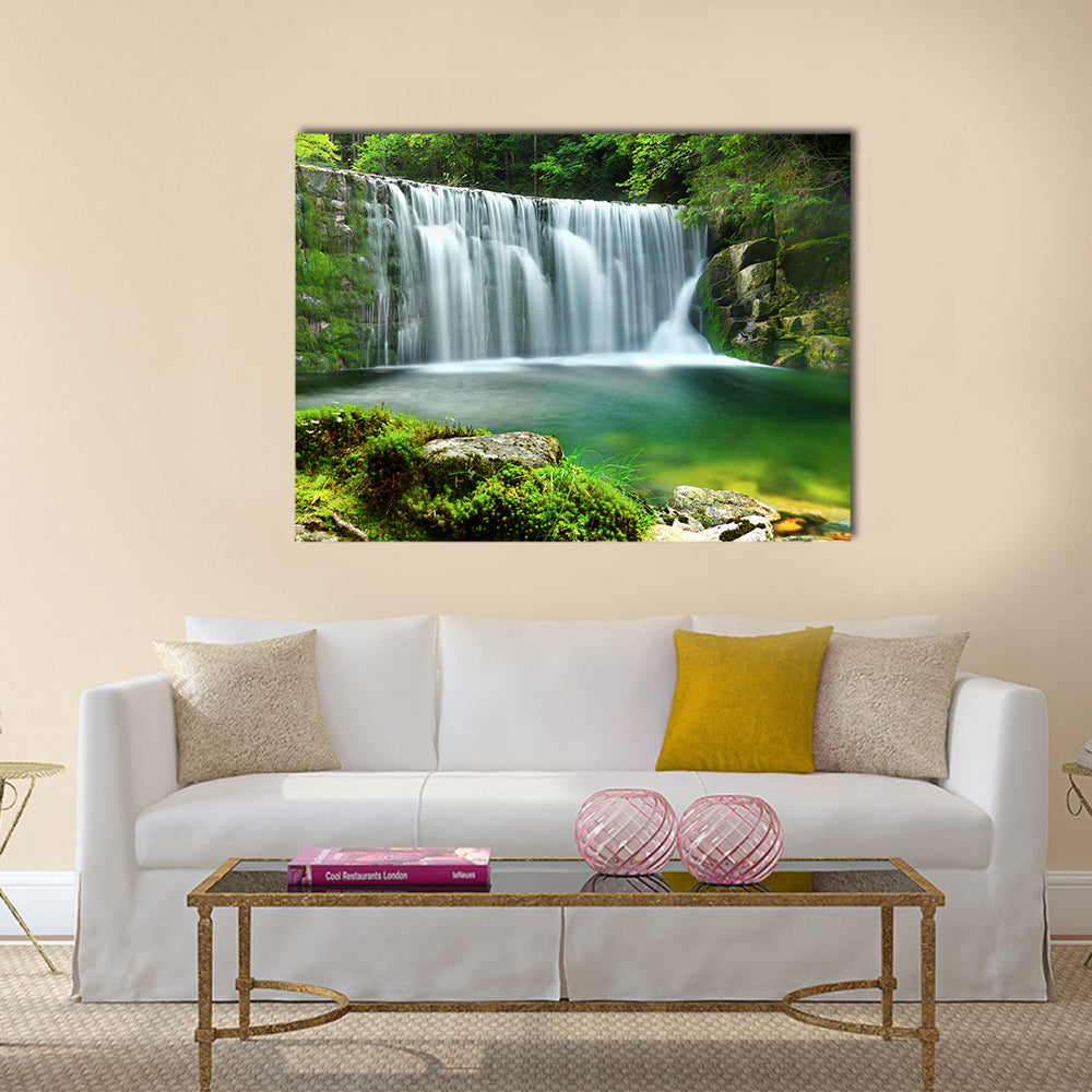 Emerald Lake Forest Waterfall Canvas Wall Art in white and green, single panel hung on a wall