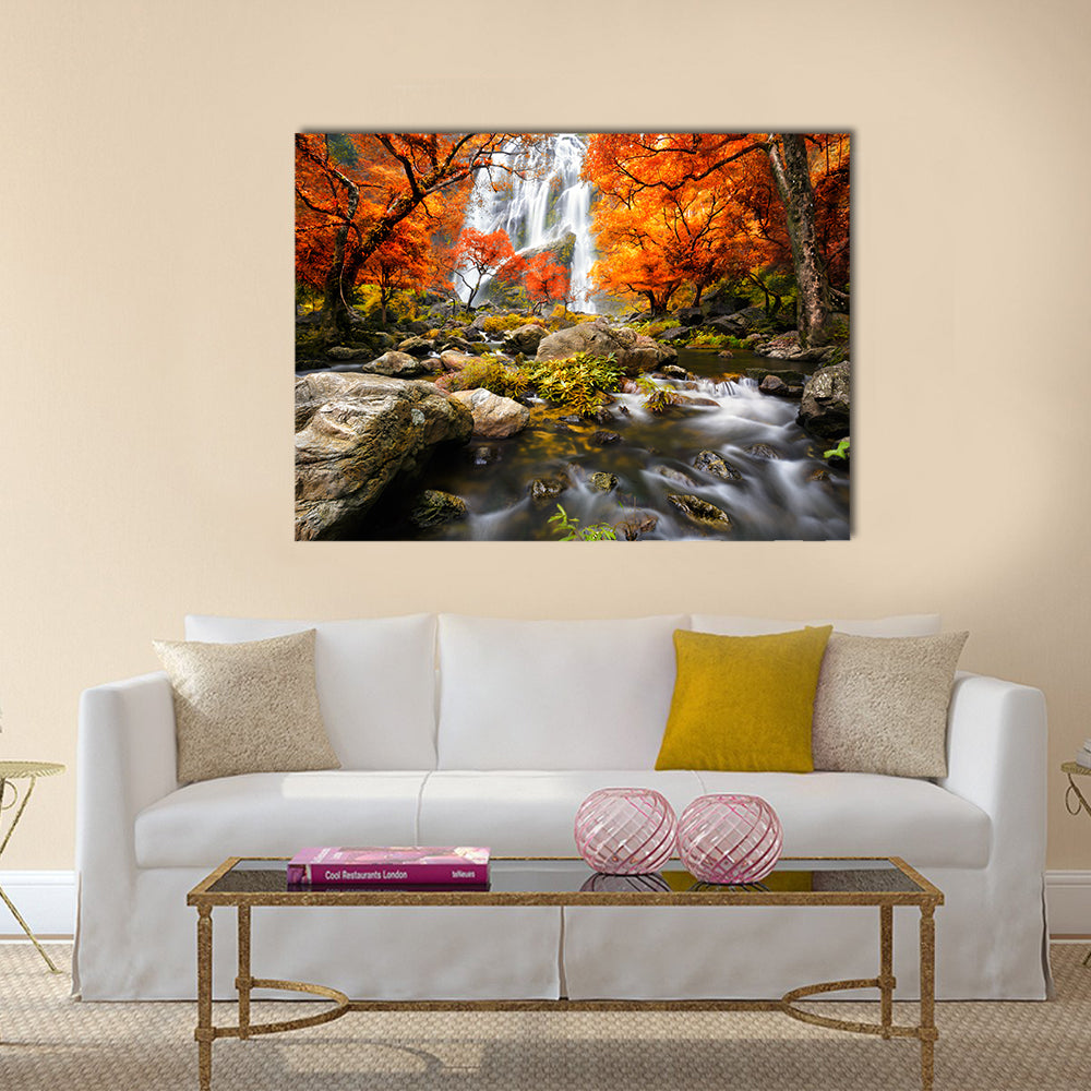 Autumn Waterfall In Kanchanaburi Thailand Canvas Wall Art in brown, orange and green, single panel hung on a wall
