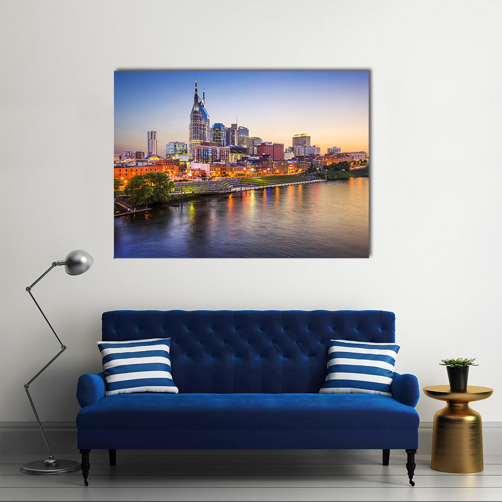 Nashville Skyline on the Cumberland River Canvas Wall Art in orange, yellow and blue, single panel hung on a wall