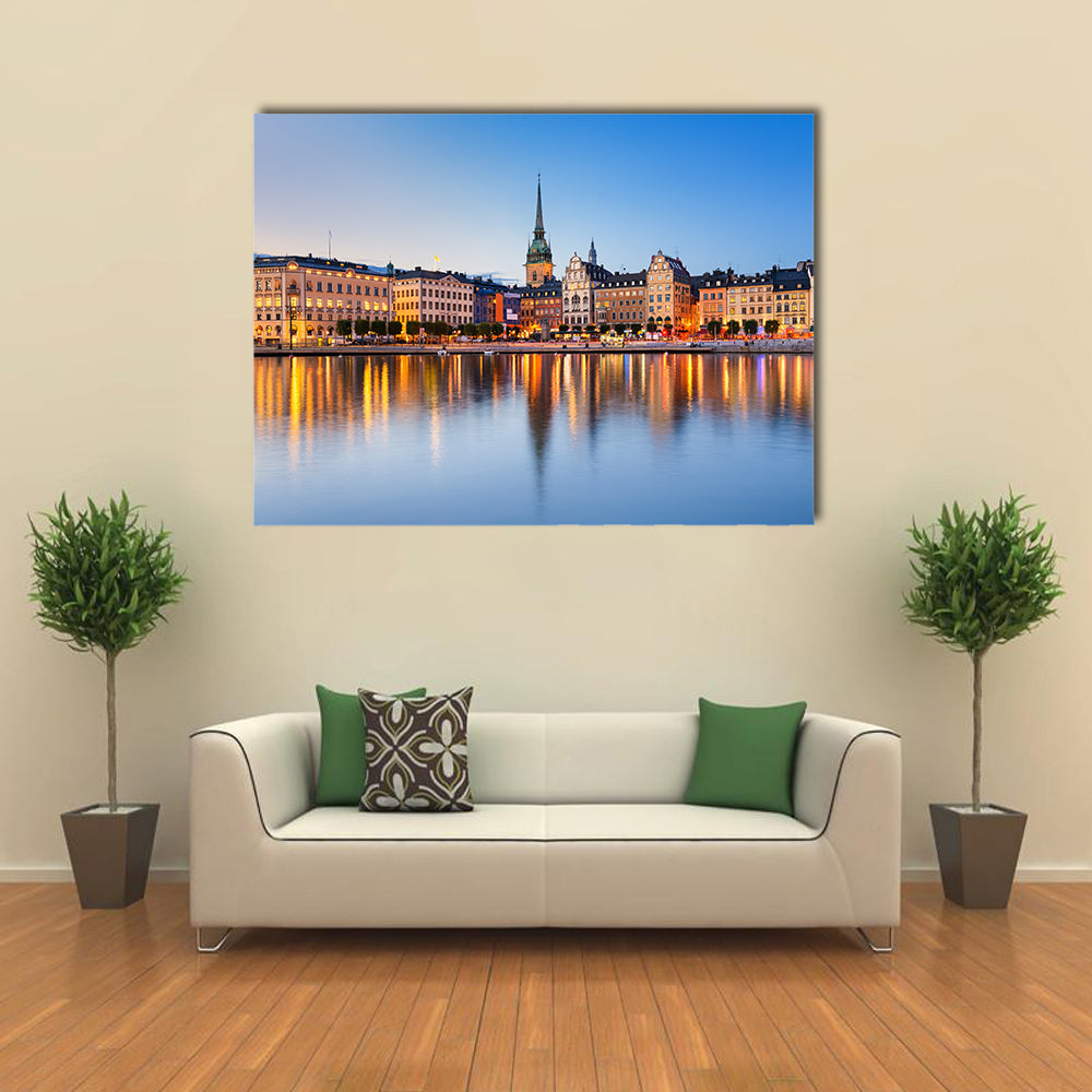 Gamla Stan In Stockholm At Evening Canvas Wall Art in orange, yellow and blue, single panel hung on a wall