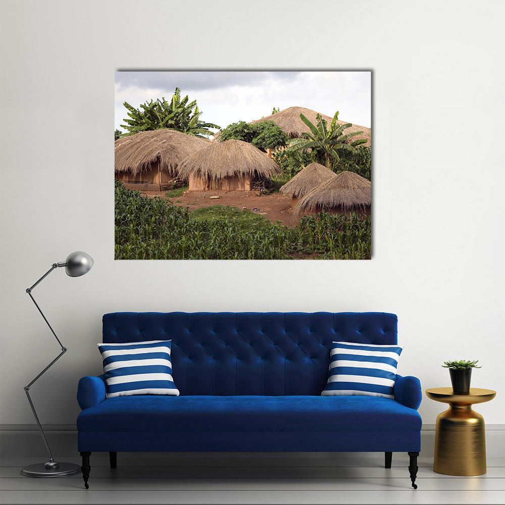Thatched Huts In Small Village In Rural Malawi Africa Canvas Wall Art in beige, brown and green, single panel hung on a wall