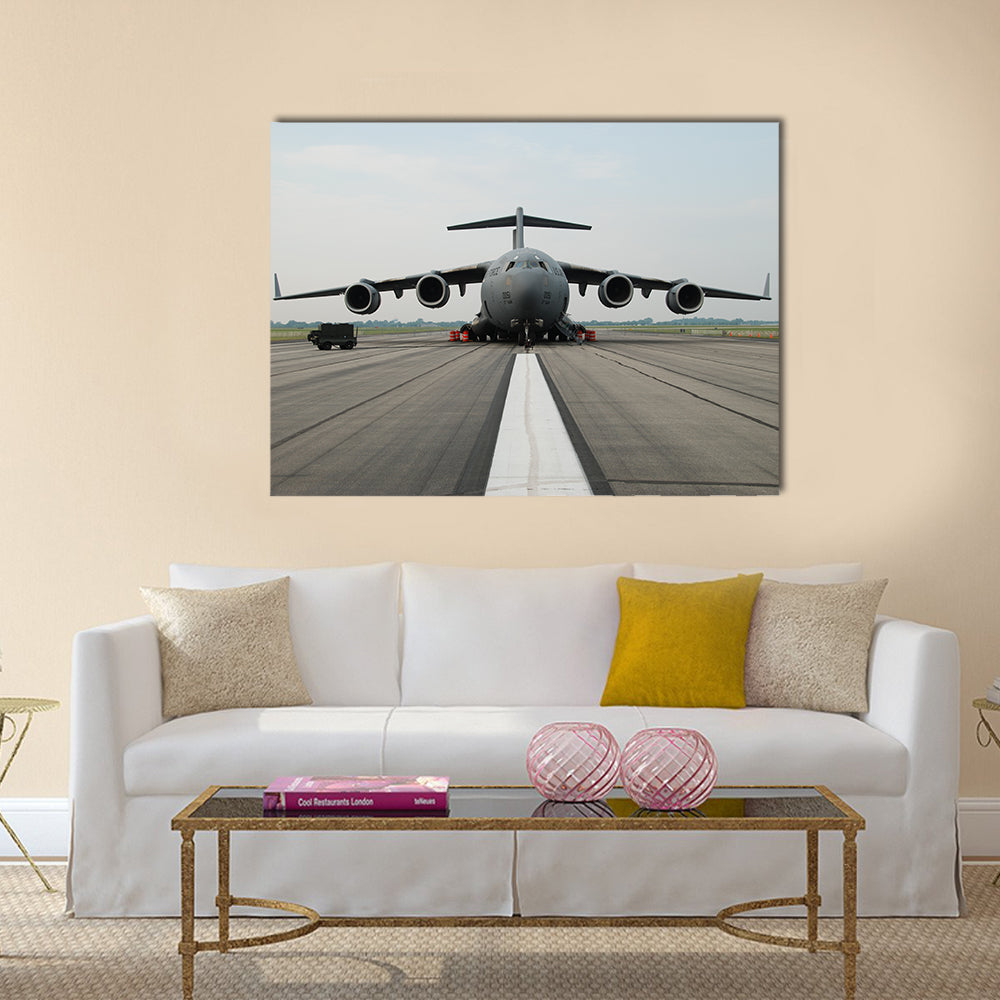 C-17 Globemaster Iii on Runway Canvas Wall Art in white, gray and blue, single panel hung on a wall