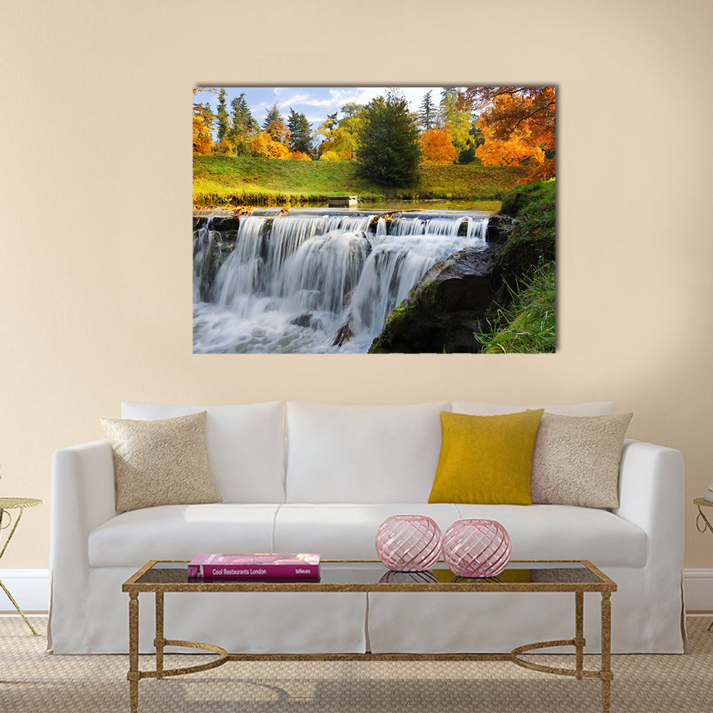 Scenic Cascades Waterfall Canvas Wall Art in white, orange and green, single panel hung on a wall