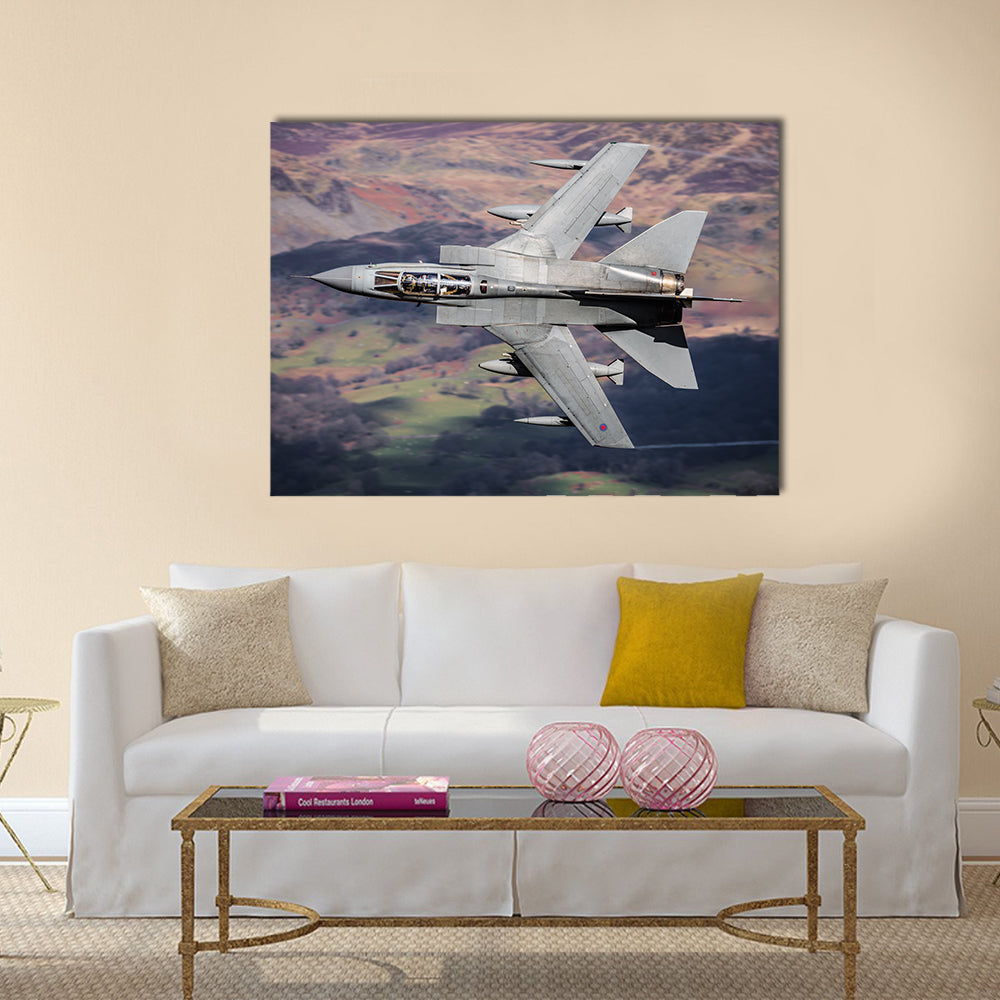 Panavia Tornado Over Mountainous Terrain Canvas Wall Art in gray, brown and green, single panel hung on a wall