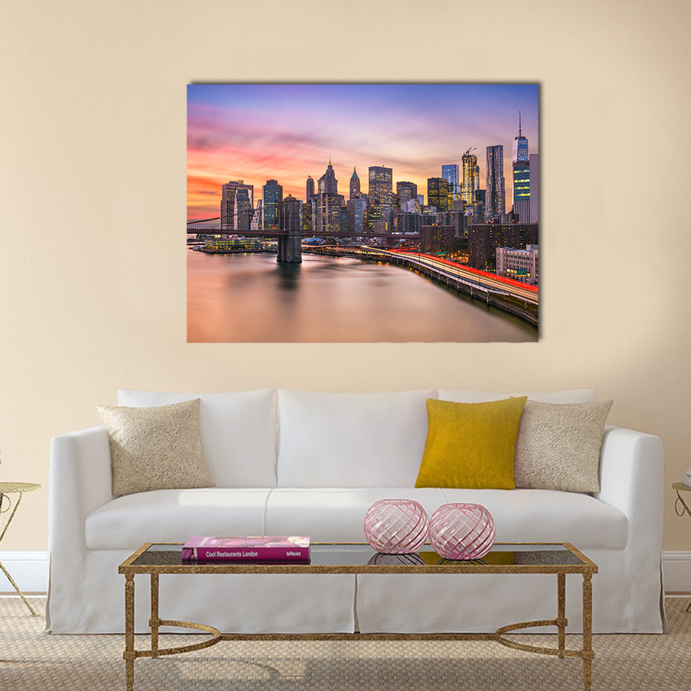 Brooklyn Bridge and Lower Manhattan Skyline Canvas Wall Art in orange, blue and purple, single panel hung on a wall