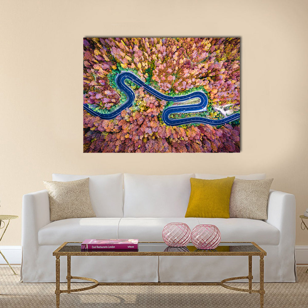 Curved Winding Road Through The Forest Canvas Wall Art in yellow, blue and pink, single panel hung on a wall