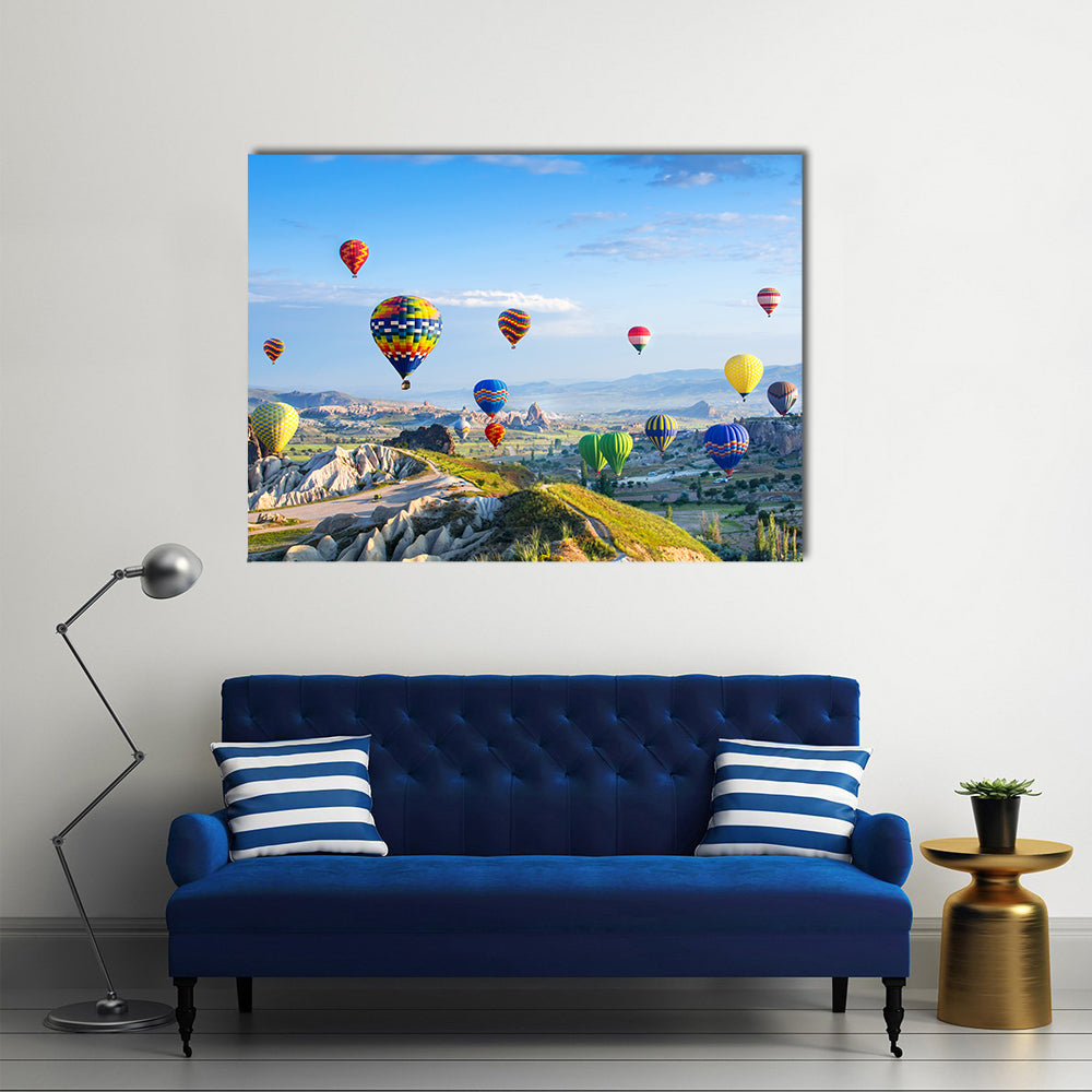 Hot Air Balloons Over Cappadocia Canvas Wall Art in blue and multicolor, single panel hung on a wall