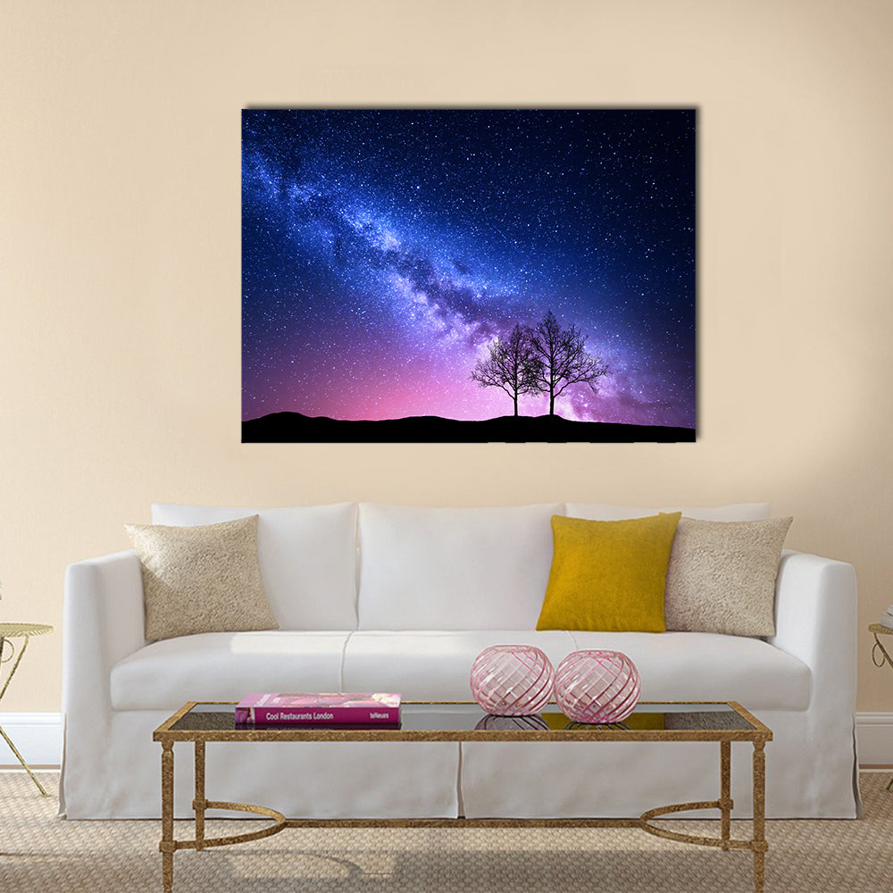 Starry Sky With Pink Milky Way Canvas Wall Art in blue, purple and pink, single panel hung on a wall