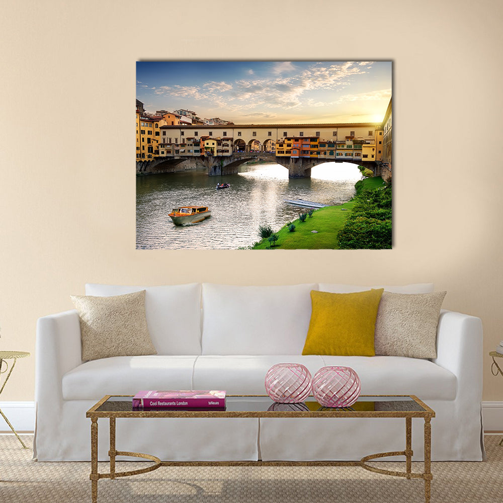 Ponte Vecchio In Florence At Sunset In Italy Canvas Wall Art in orange, yellow and blue, single panel hung on a wall
