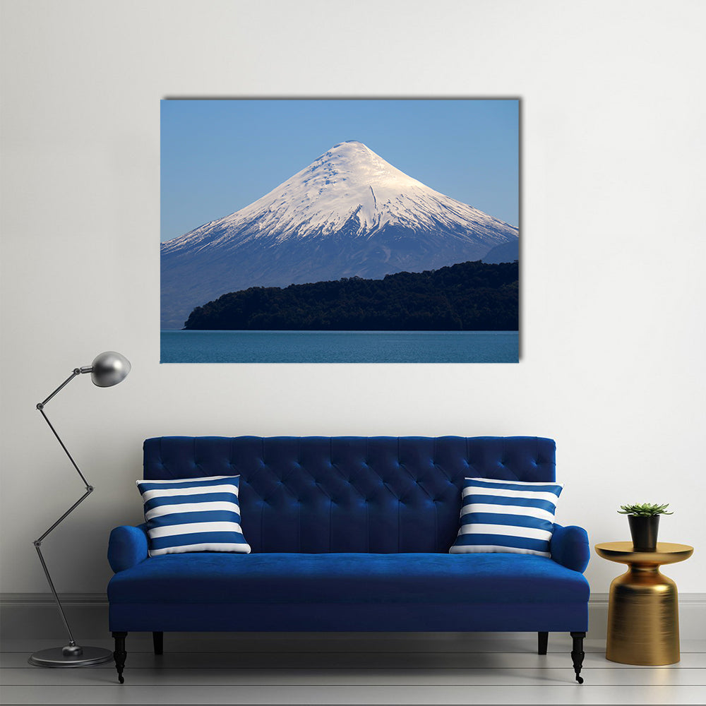 Snow-capped Volcano Over Calm Lake Canvas Wall Art in white and blue, single panel hung on a wall