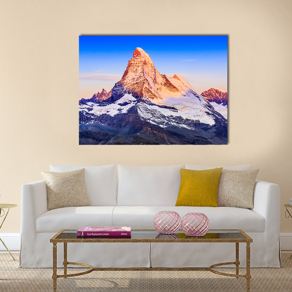 Matterhorn At Sunrise Canvas Wall Art in white, orange and blue, single panel hung on a wall