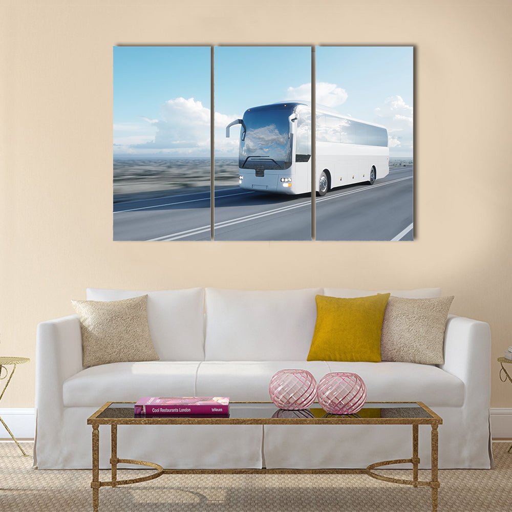 White Coach Bus on Highway Canvas Wall Art in white, gray and blue, 3 panel horizontal set hung on a wall