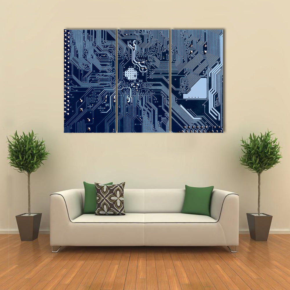Blue Circuit Board Canvas Wall Art in blue and navy, 3 panel horizontal set hung on a wall