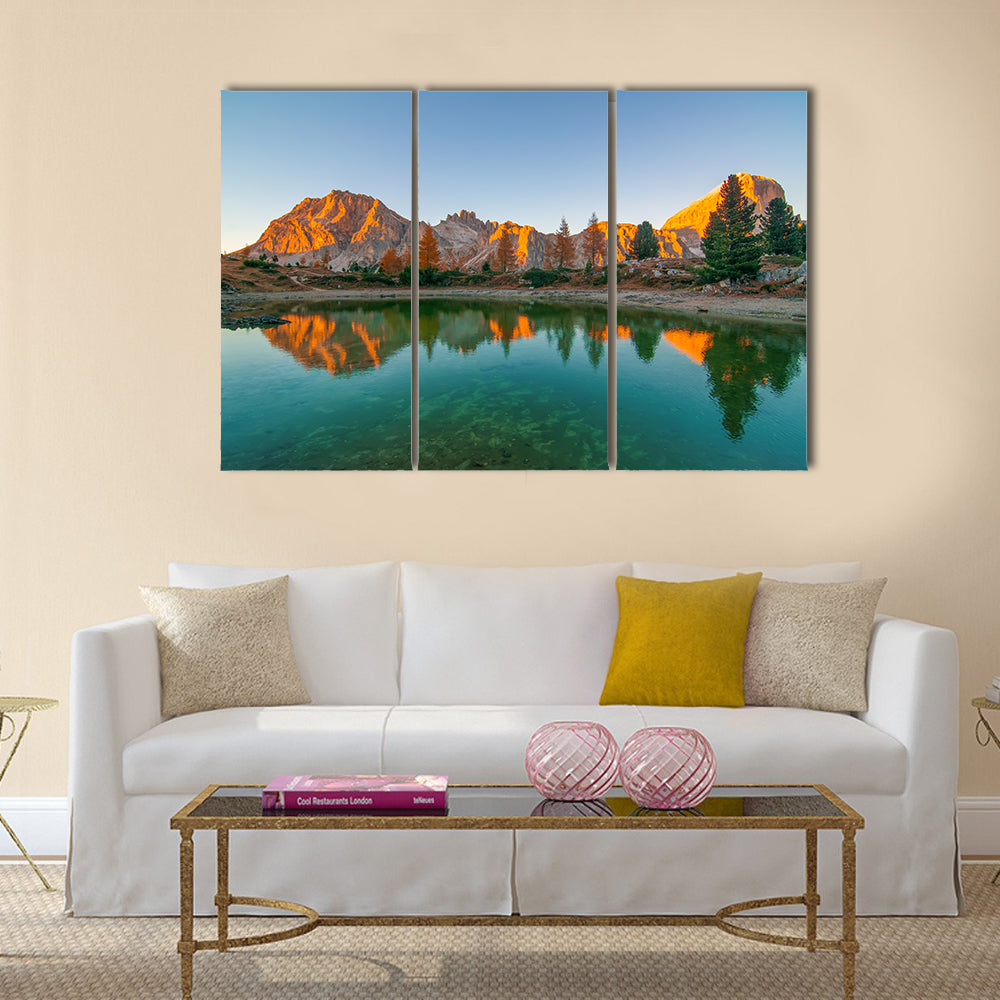 Limides Lake Reflection at Golden Hour Canvas Wall Art in orange, green and blue, 3 panel horizontal set hung on a wall
