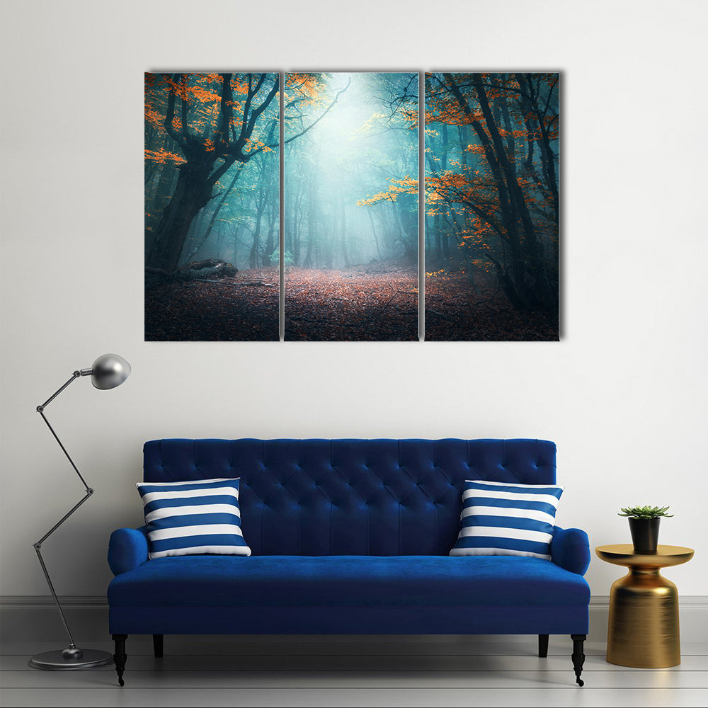 Mystical Forest in Autumn Canvas Wall Art in brown, orange and blue, 3 panel horizontal set hung on a wall