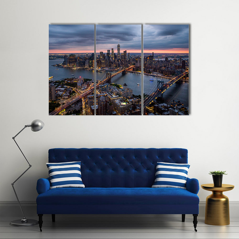 New York City at Night Canvas Wall Art in black, orange and blue, 3 panel horizontal set hung on a wall
