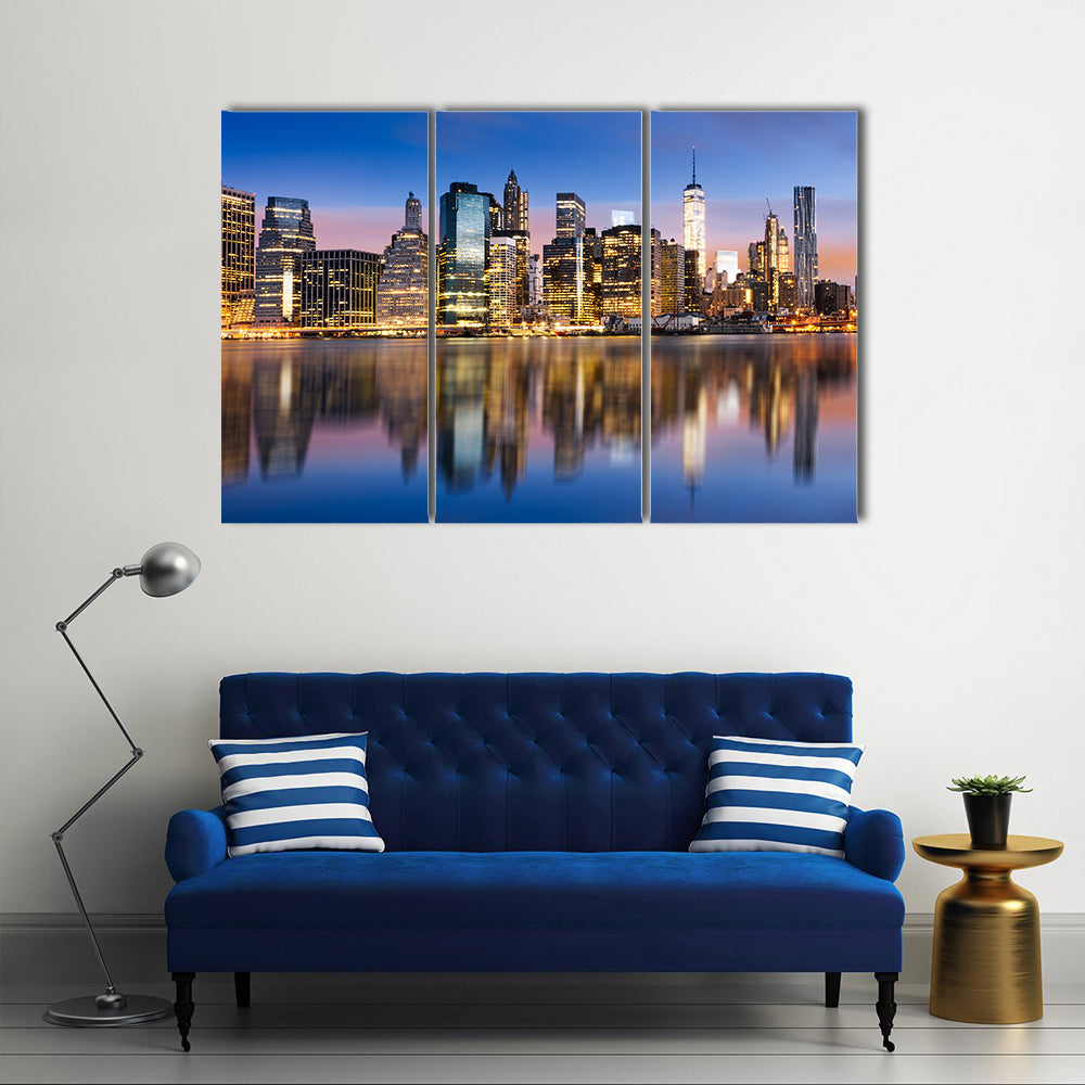Sunrise Over Manhattan Canvas Wall Art in orange, yellow and blue, 3 panel horizontal set hung on a wall