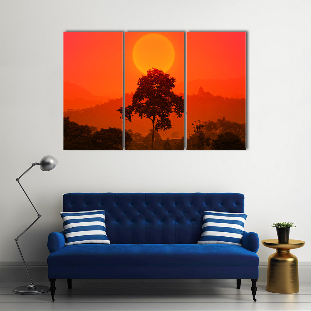 African Sunset with Big Tree Canvas Wall Art in red, orange and yellow, 3 panel horizontal set hung on a wall