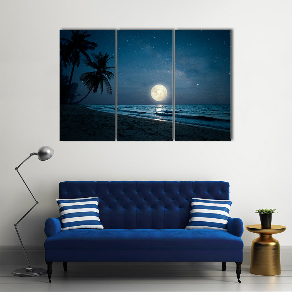 Moonlit Fantasy Tropical Beach Canvas Wall Art in black, blue and navy, 3 panel horizontal set hung on a wall