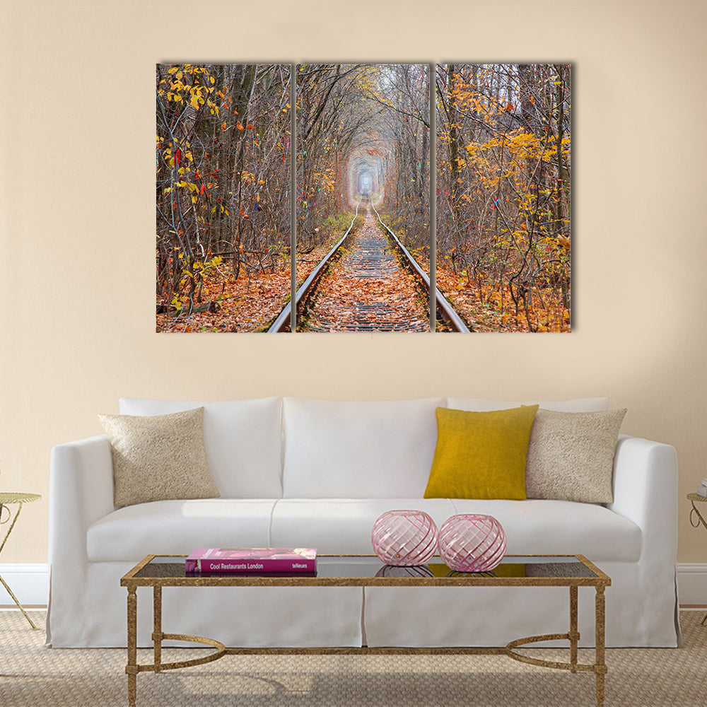 Tunnel of Love in Late Autumn Canvas Wall Art in brown, orange and yellow, 3 panel horizontal set hung on a wall