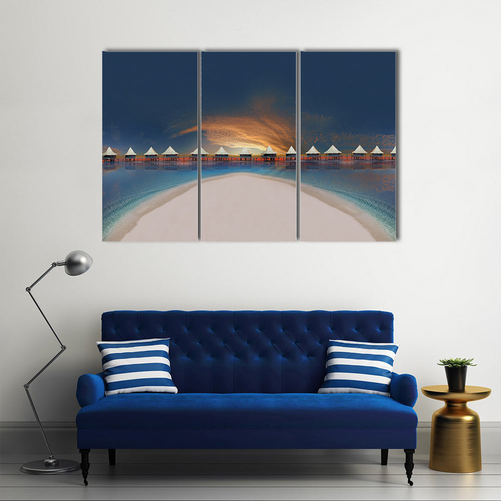 Overwater Bungalows at Sunset Canvas Wall Art in white, orange and blue, 3 panel horizontal set hung on a wall