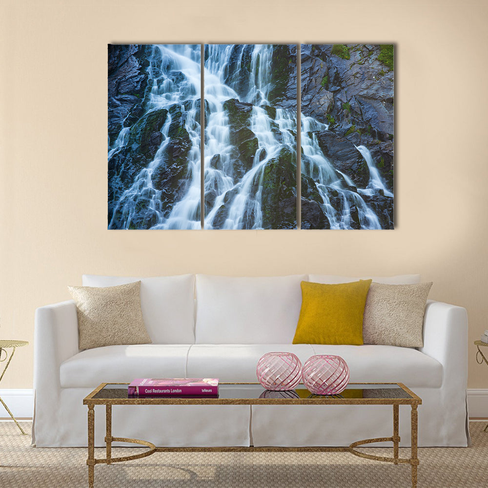 Balea Cascada Waterfall, Romania Canvas Wall Art in black, white and blue, 3 panel horizontal set hung on a wall
