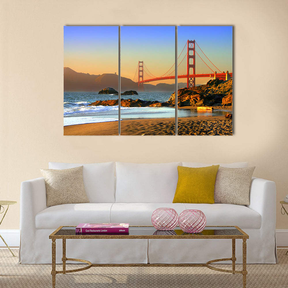 Baker Beach and Golden Gate Bridge Canvas Wall Art in brown, orange and blue, 3 panel horizontal set hung on a wall