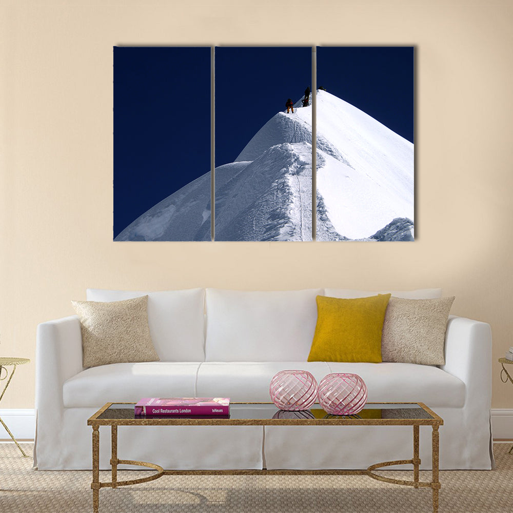 Climbers on Nepal Mountain Peak Canvas Wall Art in white, blue and navy, 3 panel horizontal set hung on a wall