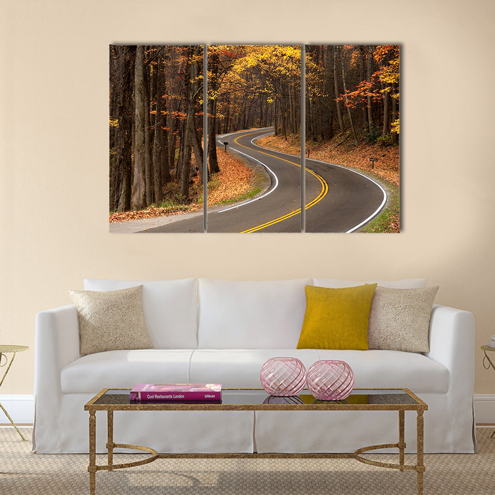 S-curve Road in Great Smokey Mountains Canvas Wall Art in brown, orange and yellow, 3 panel horizontal set hung on a wall