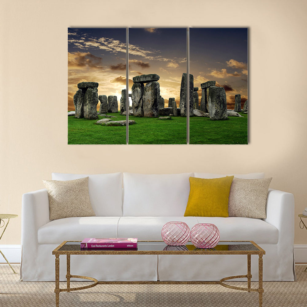 Stonehenge at Sunset Canvas Wall Art in gray, orange and green, 3 panel horizontal set hung on a wall