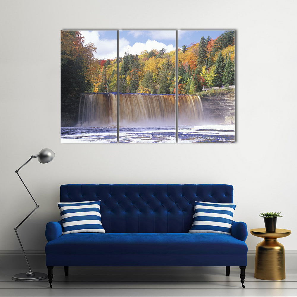 Autumn Waterfall in Michigan Canvas Wall Art in brown, yellow and green, 3 panel horizontal set hung on a wall