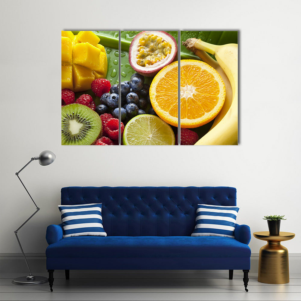 Fresh Tropical Fruit Still Life Canvas Wall Art in orange, yellow and green, 3 panel horizontal set hung on a wall