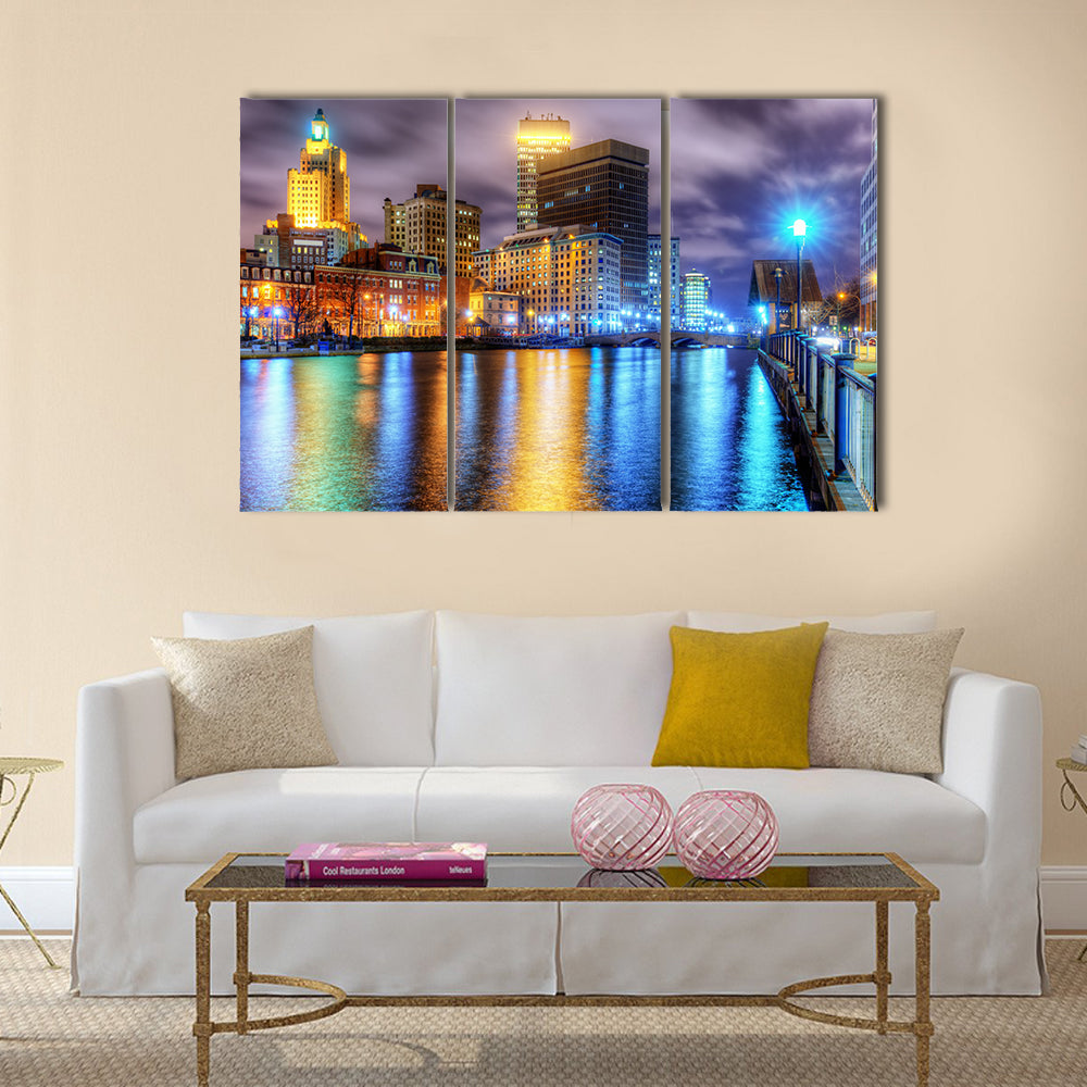 Downtown Providence Skyline with Water Reflections Canvas Wall Art in yellow, blue and purple, 3 panel horizontal set hung on a wall