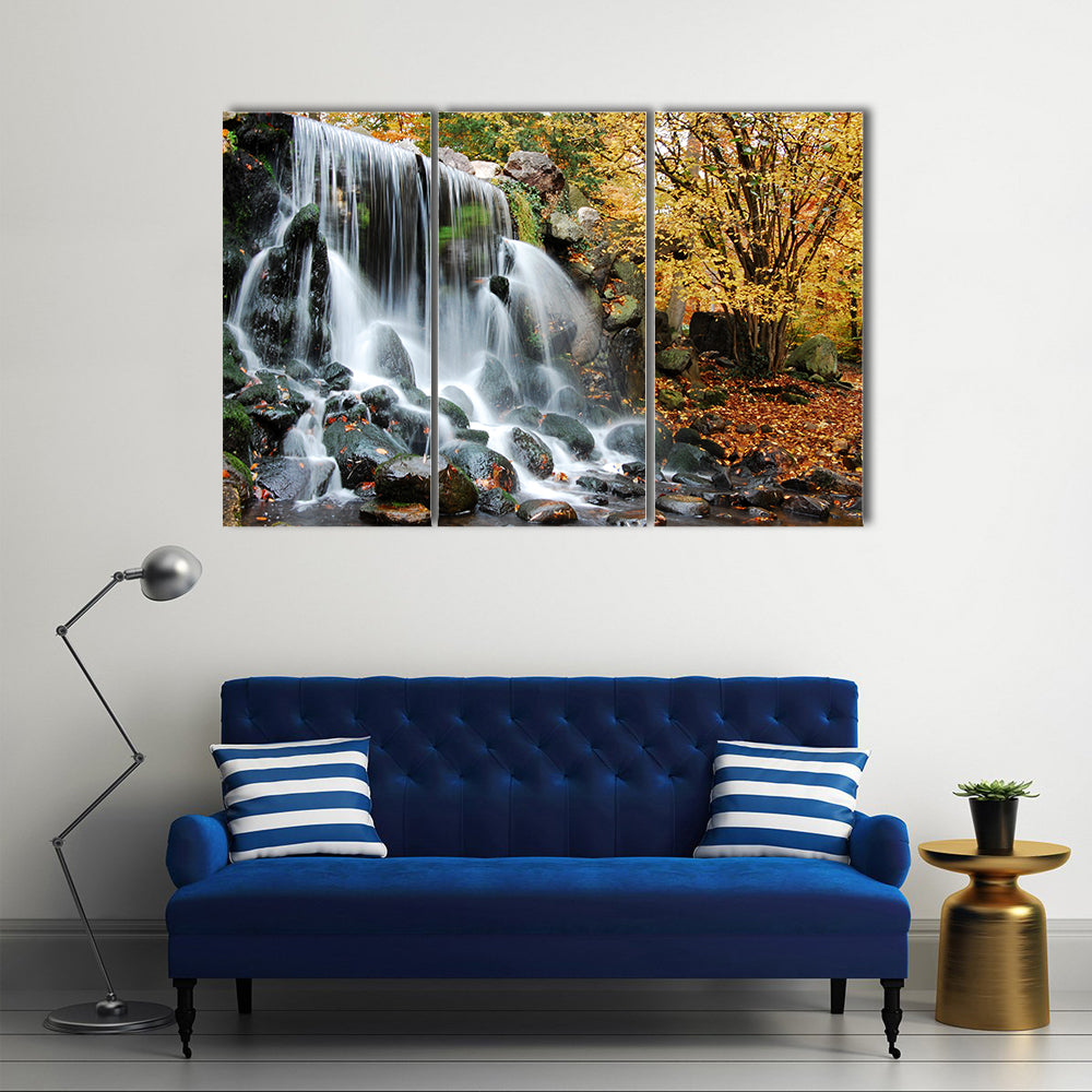Autumn Waterfall in Sonsbeek Park Arnhem Canvas Wall Art in black, white and yellow, 3 panel horizontal set hung on a wall
