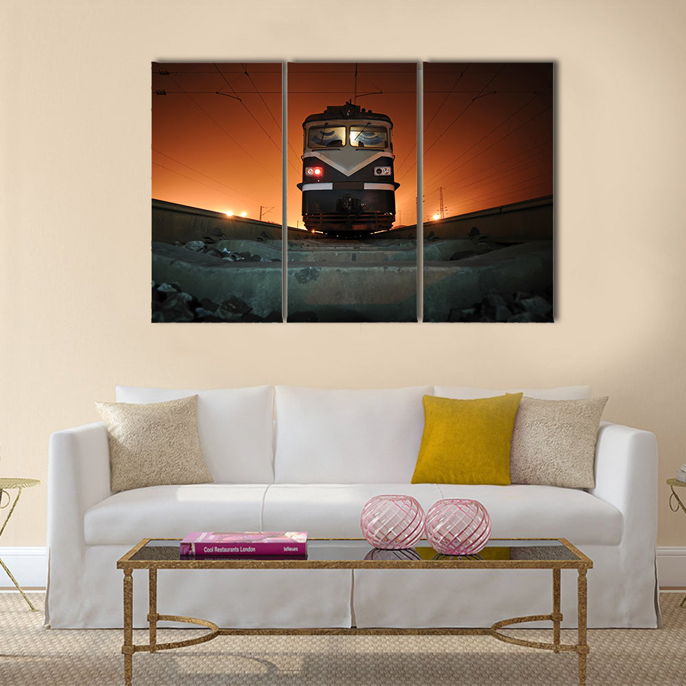 Chinese Electric Train at Night Canvas Wall Art in black, gray and orange, 3 panel horizontal set hung on a wall