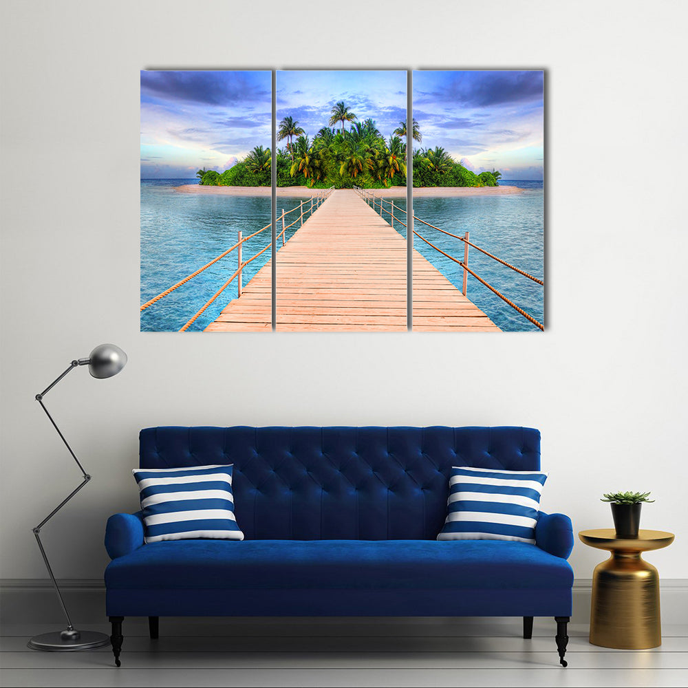 Wooden Pier to Tropical Maldives Island Canvas Wall Art in beige, green and blue, 3 panel horizontal set hung on a wall