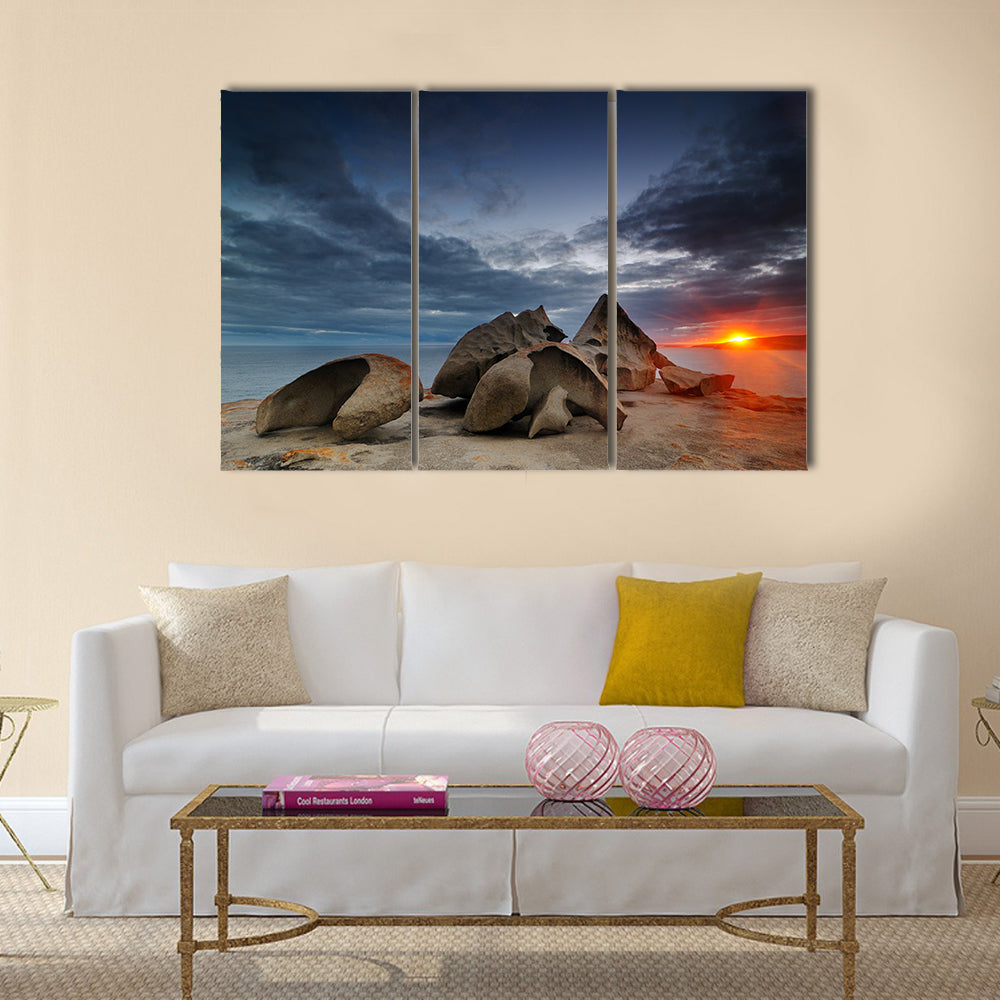 Remarkable Rocks on Kangaroo Island Beach Canvas Wall Art in gray, orange and blue, 3 panel horizontal set hung on a wall