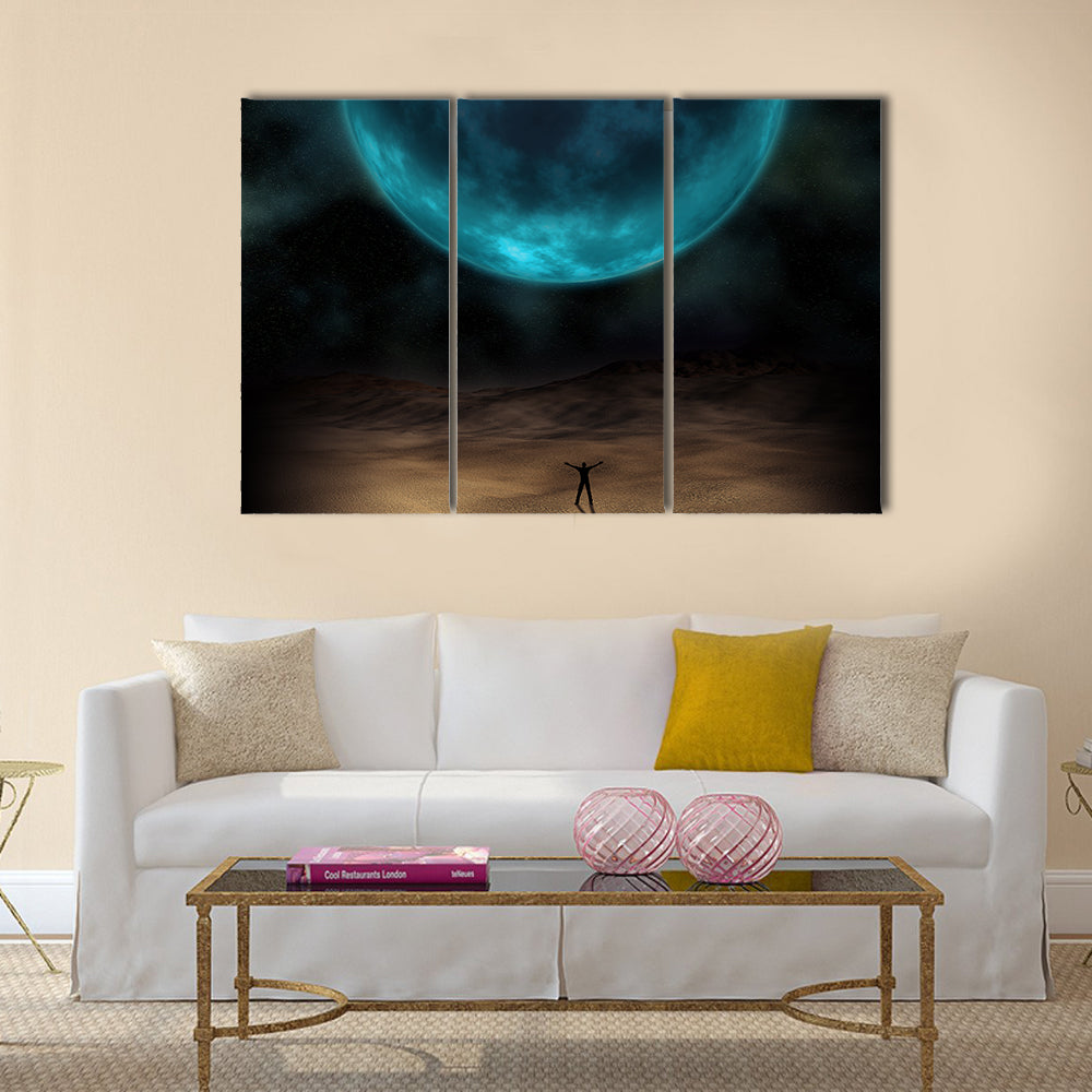 Silhouetted Figure Beneath Giant Blue Planet Canvas Wall Art
