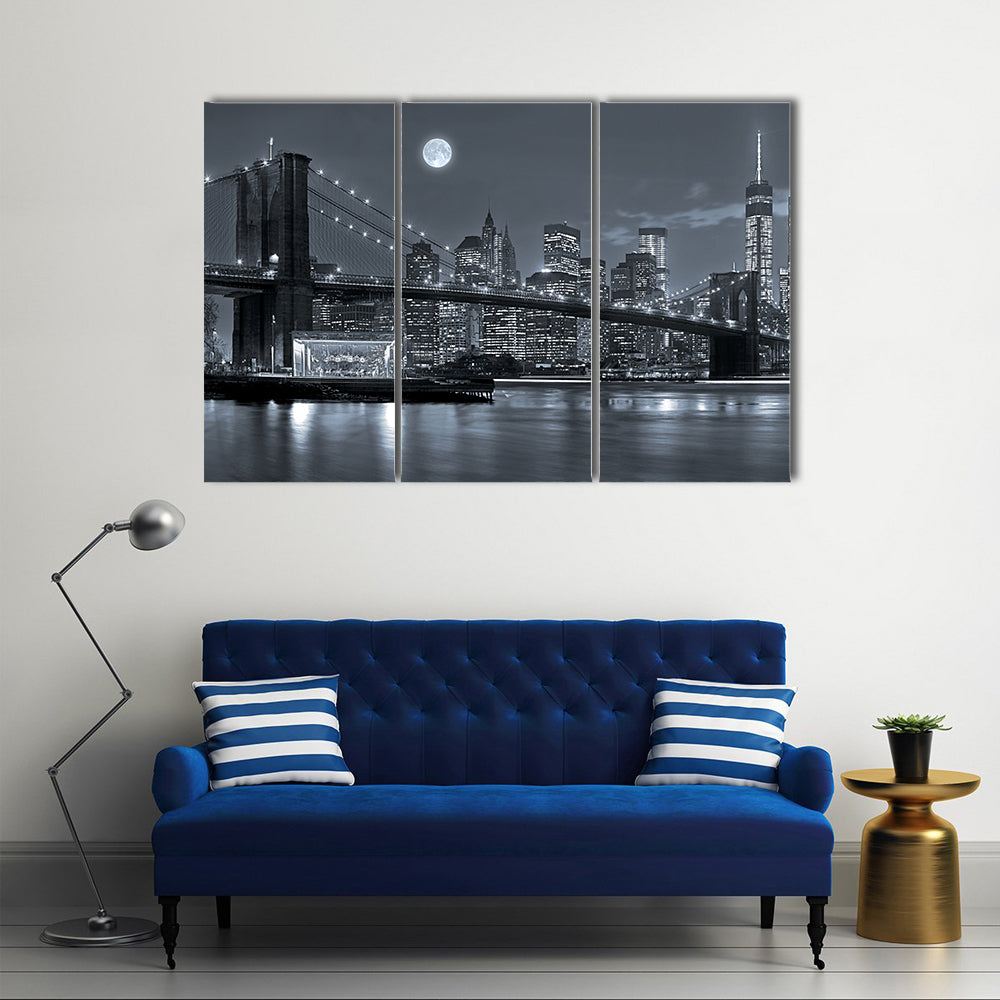 Brooklyn Bridge and Lower Manhattan by Moonlight Canvas Wall Art in black, white and gray, 3 panel horizontal set hung on a wall