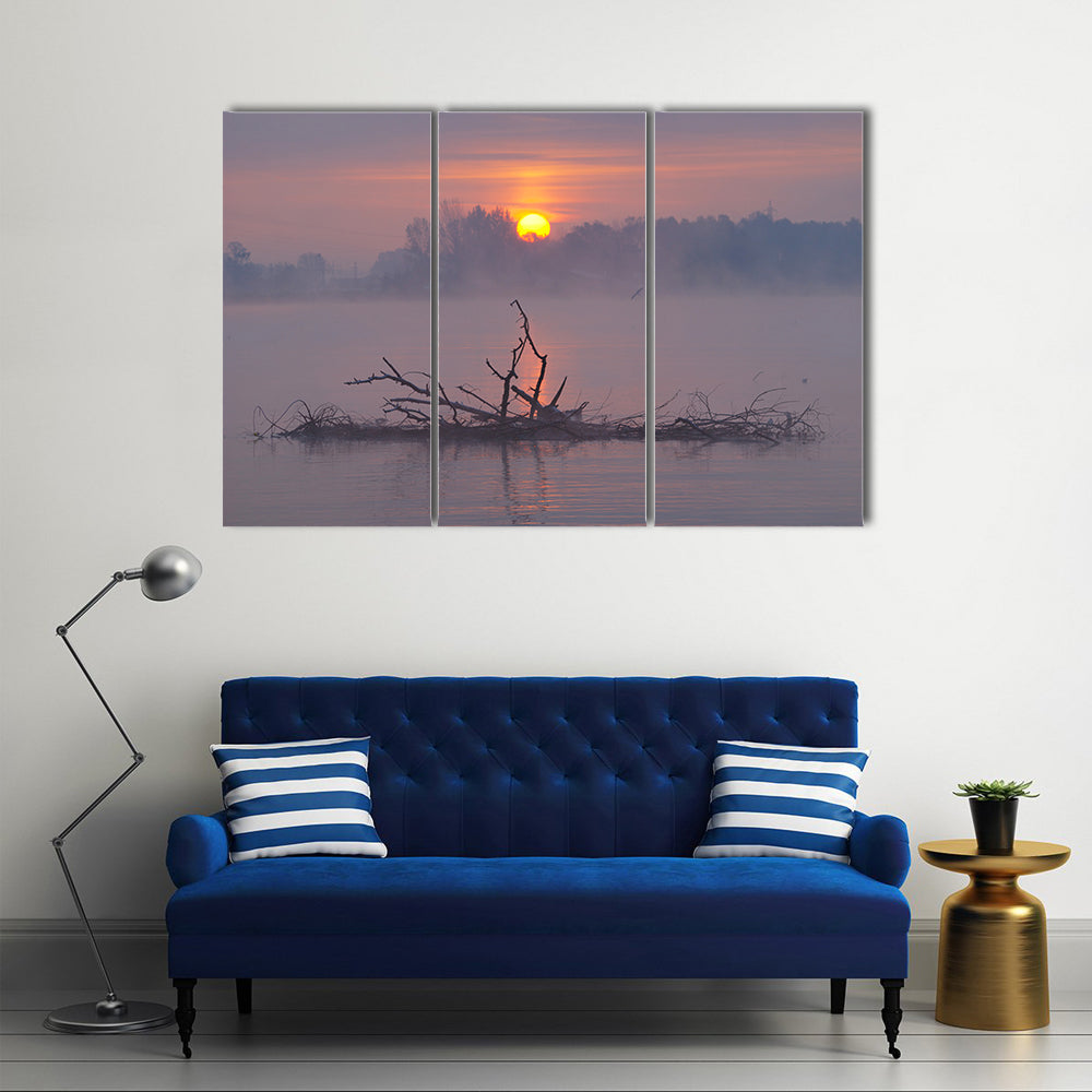 Misty Lake Sunrise Canvas Wall Art in gray, orange and purple, 3 panel horizontal set hung on a wall