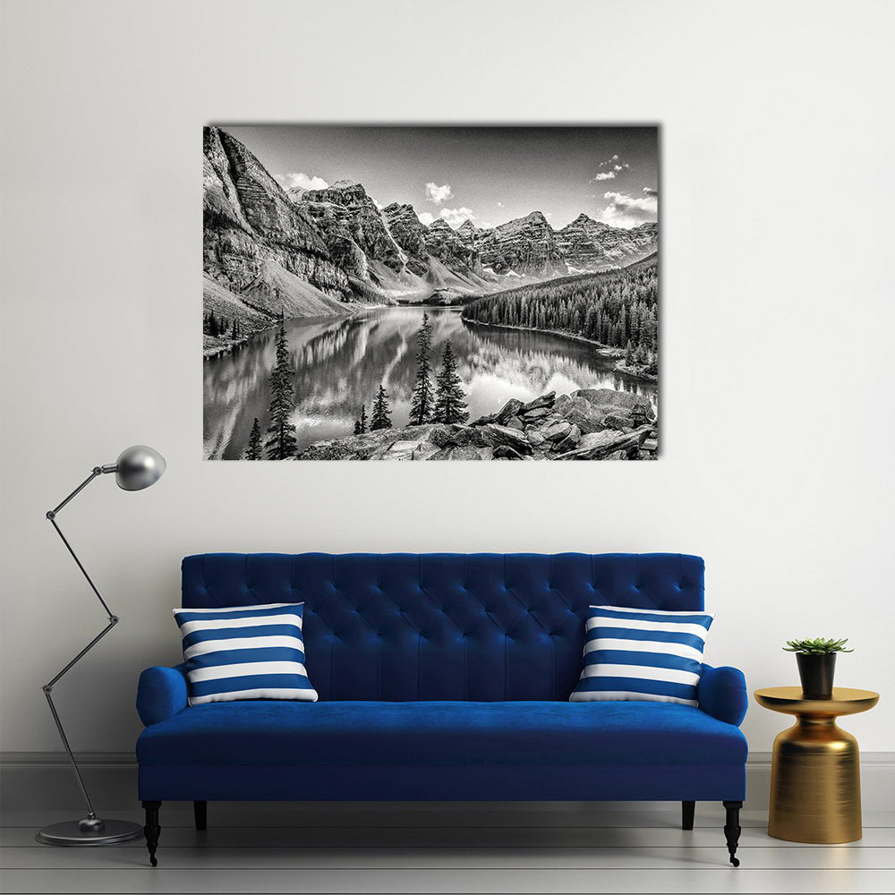 Glacial Mountain Lake with Pine Reflections Canvas Wall Art in black, white and gray, 3 panel horizontal set hung on a wall