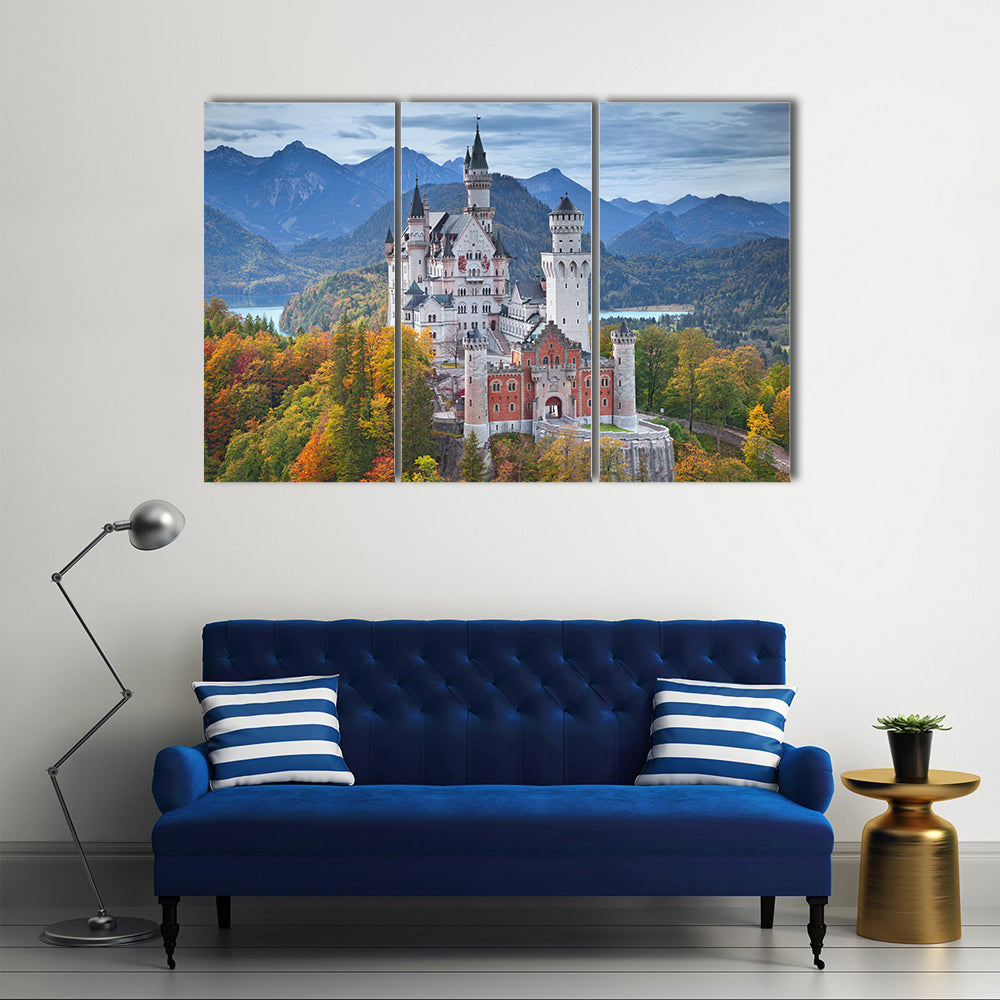 Neuschwanstein Castle with Turquoise Lake Canvas Wall Art in white, green and blue, 3 panel horizontal set hung on a wall