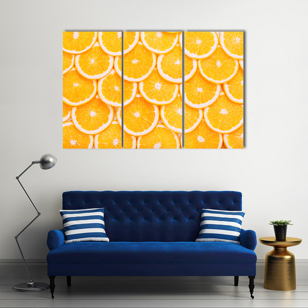 Fresh Orange Slices Pattern Canvas Wall Art in orange and yellow, 3 panel horizontal set hung on a wall