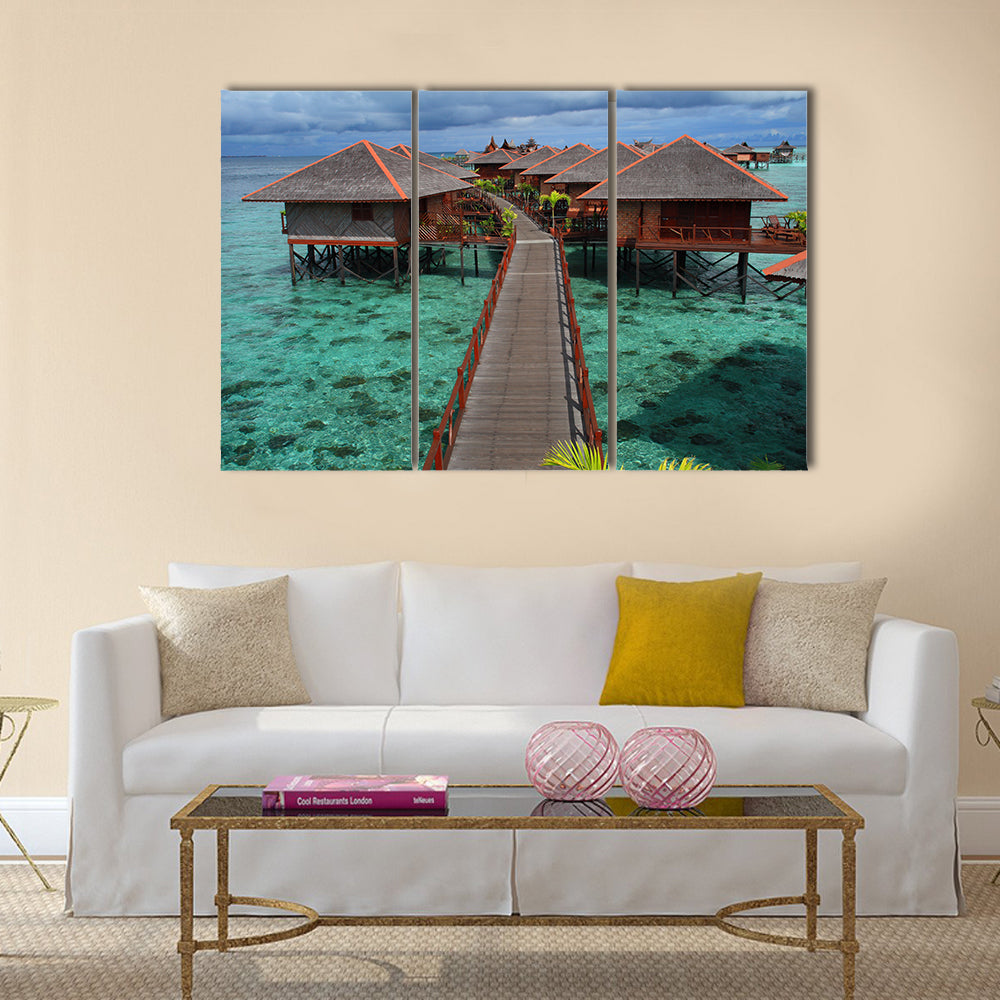 Mabul Island Overwater Bungalows Canvas Wall Art in brown, green and blue, 3 panel horizontal set hung on a wall
