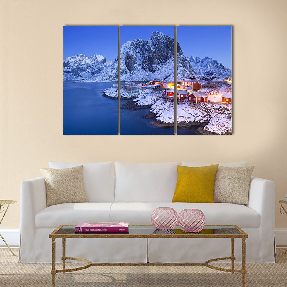 Lofoten Fisherman's Cabins Canvas Wall Art in white, orange and blue, 3 panel horizontal set hung on a wall