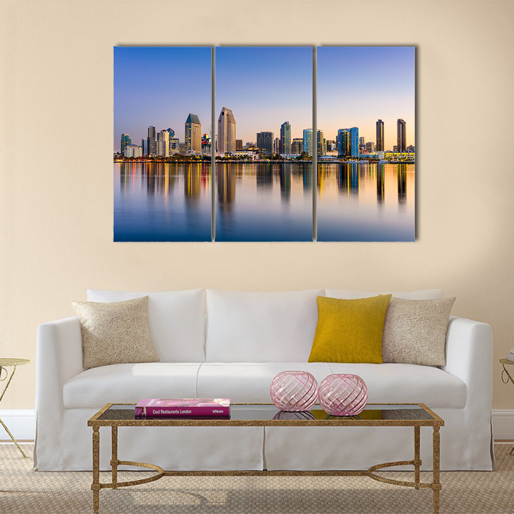 San Diego Skyline at Dusk Canvas Wall Art in orange, yellow and blue, 3 panel horizontal set hung on a wall