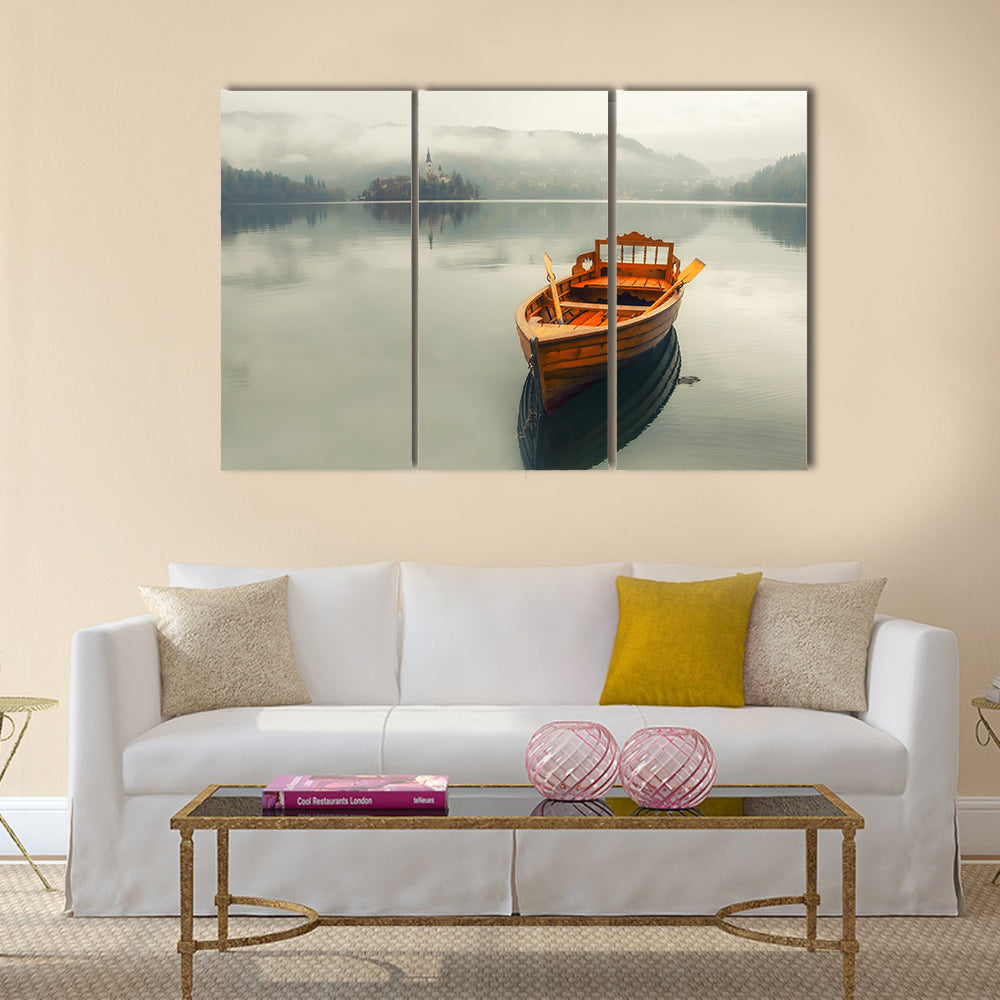 Rowboat on Foggy Lake with Island Church Canvas Wall Art in gray, beige and brown, 3 panel horizontal set hung on a wall