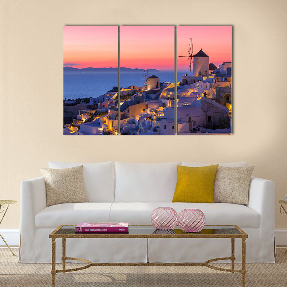 Sunset in Santorini Canvas Wall Art in orange, blue and pink, 3 panel horizontal set hung on a wall